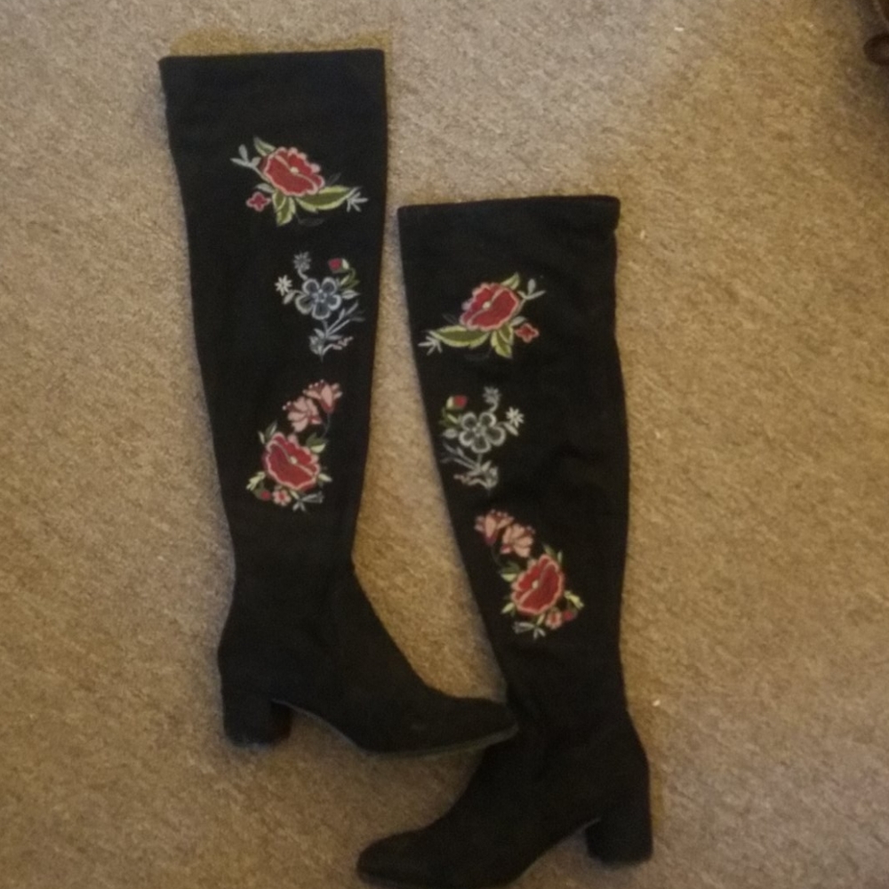 Knee high embroidered black boots.